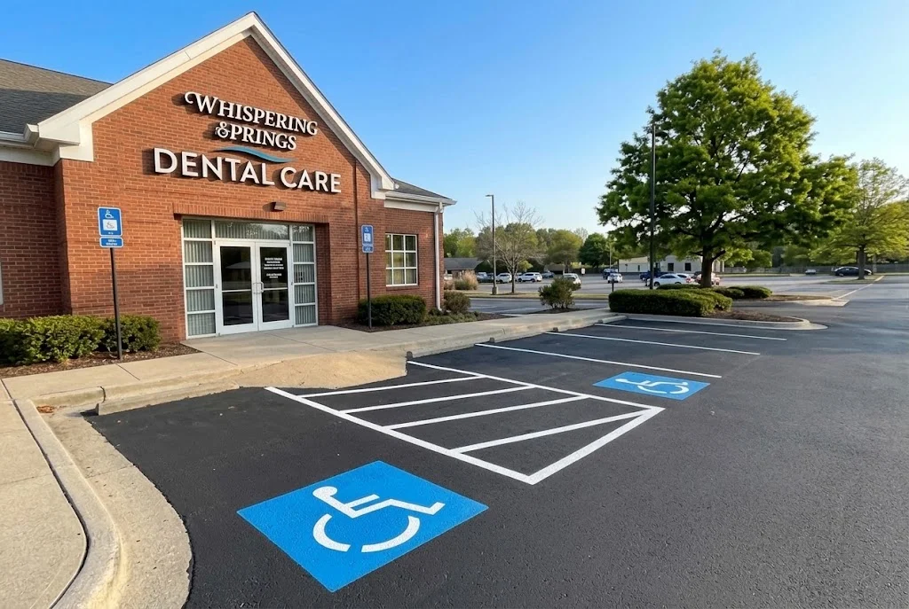 Newly paved asphalt parking lot with white striping and blue ADA accessible parking space markings